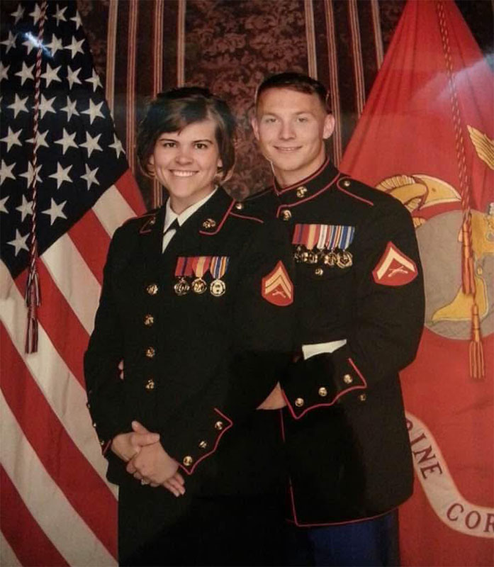 Marines in uniforms in fornt of flags